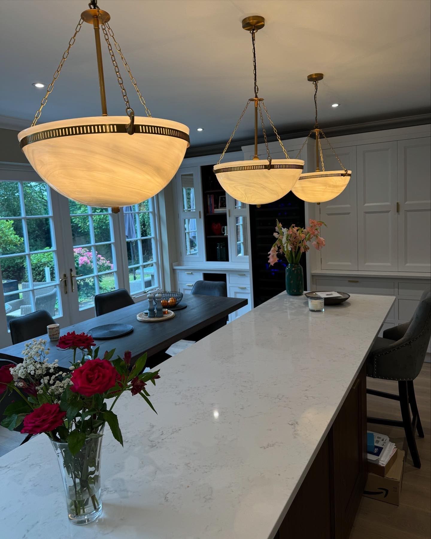 Alabaster pendant lights hung over a kitchen island